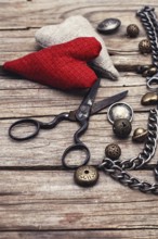 Metal chain and beads for craft on wooden background