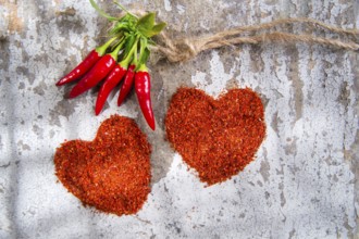 Presentation of two hearts made of chili powder
