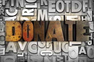 The word DONATE written in vintage letterpress type