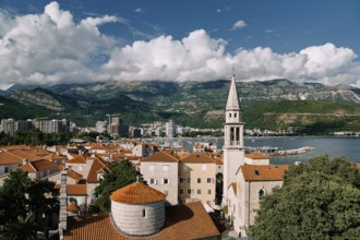 Church of the Holy Trinity near St. John Cathedral among old houses with red roofs. Budva,