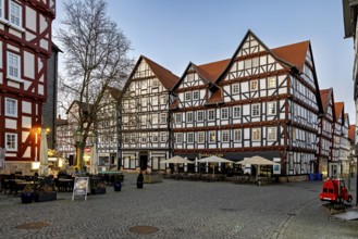 Historic half-timbered houses with a café in a quiet evening mood, The old town centre of Melsungen