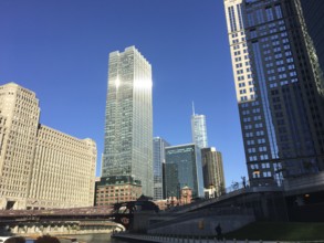 City skyline with skyscrapers and river under a bright blue sky, chicago, illinois, usa
