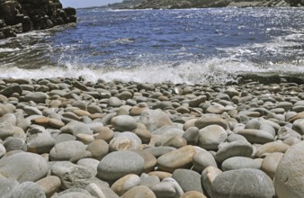 Power of nature grinded rock into round pebbles on a beach in South Africa