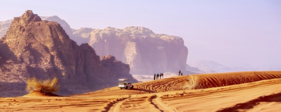 Jordan, Wadi Rum, November 2, 2022: Jeep safari in desert. Tourists and off-road car trace on dune