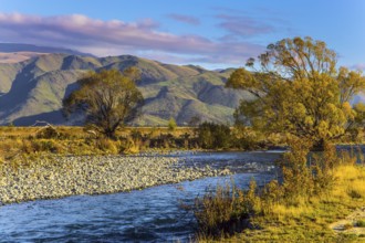 Valley at the foot of the Clay Cliffs and a slow river. Fabulous country of New Zealand. Travel to