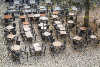 View from above outdoor empty tables and chairs of cafe in France