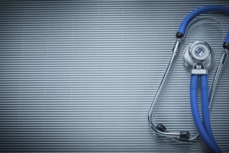 Stethoscope on striped background medicine concept