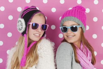 Two fourteen years old teens as girlfriends in winter