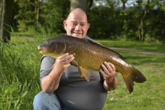 Proud fisherman with self captived carp