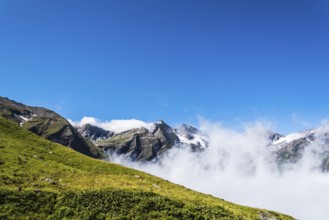 Scenic view of Alpine valley with sea of clouds. Grossglockner, Austria. Space for copy