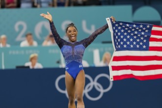 Simone Biles (USA) of the United States celebrates with the fans after winning the Artistic