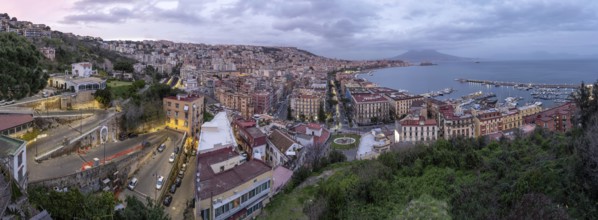 Panorama of Naples with the Gulf and the famous Vesuvius in the clouds after sunset