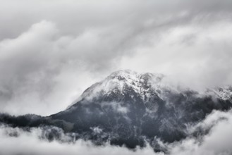 Snowy Peak of Mountain Range in Clouds Obermaiselstein, Germany, Europe