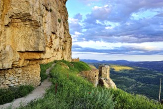 Landscape at sunset with large overhanging rocks and mountain views. Ares in Spain