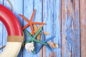 Beach poster on wooden background with starfishes and life buoy