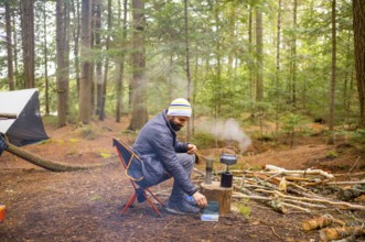 Man in a Camping Sight of Natural Reserve in Little Tupper Lake Park, New York State - US