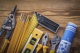Composition of building tools on vintage wooden board top view