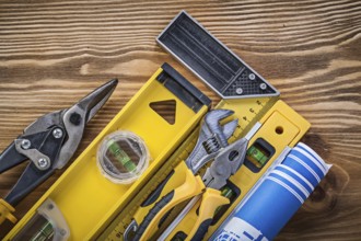 Composition of construction tools on vintage wooden board top view