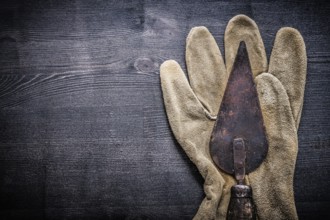 Horizontal view vintage tools putty spattle on glove