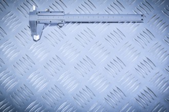 Vernier caliper on grooved metal plate construction concept