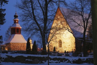 Christmas night scenery in Finland, church in snow, xmas tree