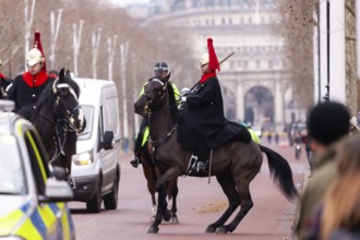 Mounted horse guards in ceremonial uniforms on a street in the City of Westminster, Greater London,