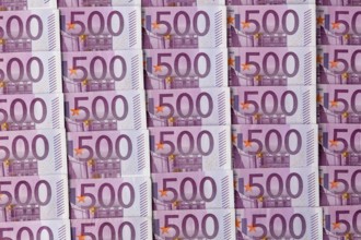 Many five hundred euro banknotes lying next to each other. Symbolic photo for wealth and investment