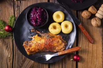 Roast goose with baked apples, red cabbage and dumplings