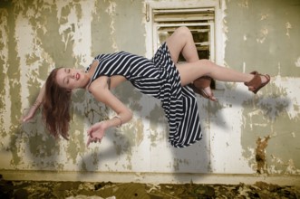 Beautiful young woman floating in the air