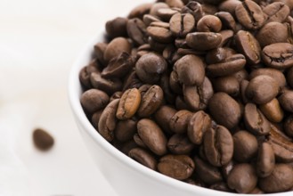 Bowl of caffee beans on a white background