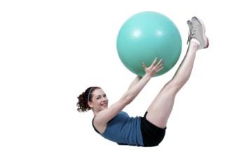 A beautiful young woman working with an aerobic exercise ball