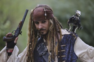 Man in pirate costume with bird on his shoulder