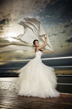 Pretty lady in a wedding dress on deck