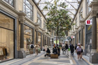 Copenhagen, Denmark, May 31, 2023: People in Jorcks Passage, a passageway and building with shops