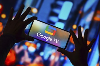 In this photo illustration, the Google TV logo is displayed on a smartphone screen