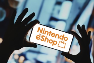 In this photo illustration, the Nintendo eShop logo is displayed on a smartphone screen