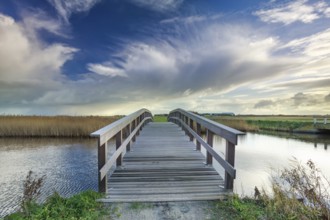 Wooden bridge via river and blue sky, Netherlands