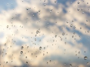 Water drops of rain on blue glass background. Rain drops on window