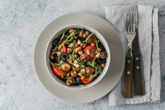 Salad with arugula, mini champignons, cherry tomatoes, black olives, pine nuts. Vegetarian salad