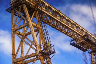 Worker climbing on a crane