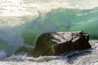 Waves breaking on the stone during sunset