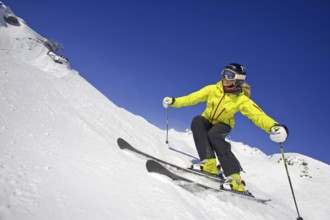 Skier in action, blonde woman, 25, 30, years, downhill skiing, Austria, Europe