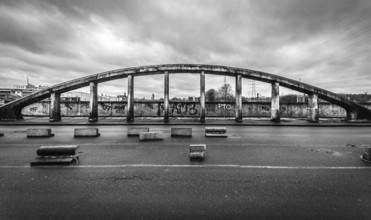 Belgium, 03 15 2019: The dilapidated Albert Bridge with dark rainy sky in black and white, Europe