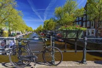Bikes on the bridge that crosses the canal in Amsterdam, Netherlands