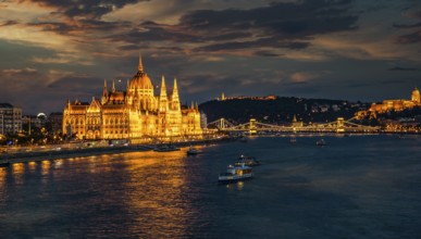 View of hungarian Parliament and Chain Bridge on river Danubeat night