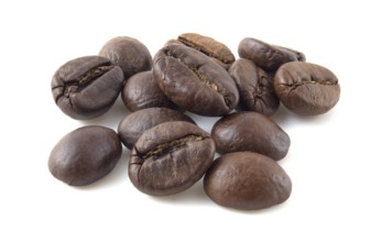 Roasted coffee beans close up isolated on white background