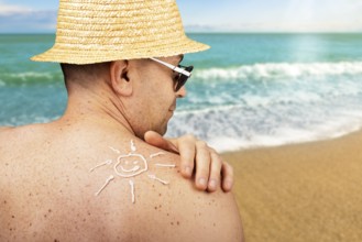 Middle aged caucasian male model applying sunscreen