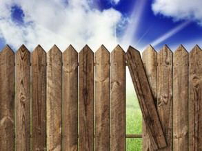 Wooden fence over the backyard with sky and sun