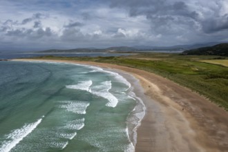 A panorama aerial view of the golden sand beach and turquoise waters of the beach at Narin-Portnoo
