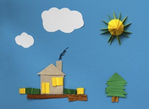 House made ??of paper over blue paper background